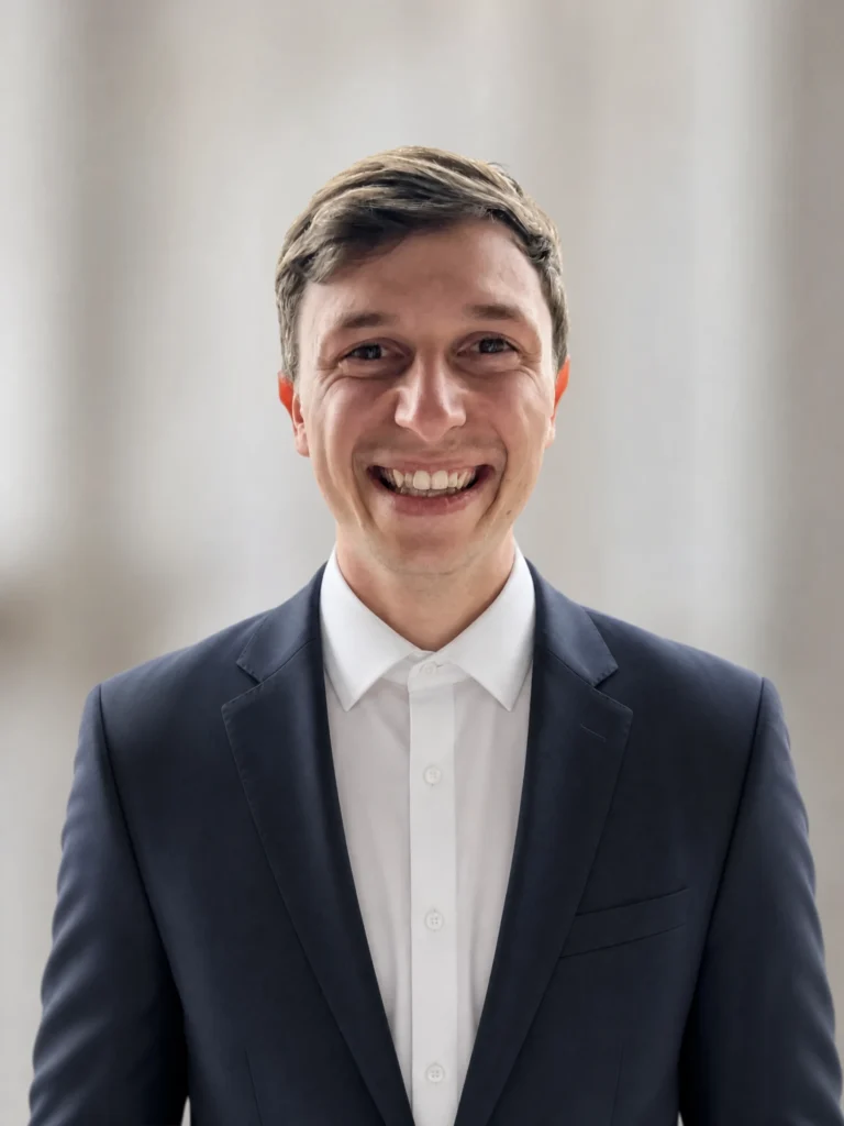 Peter Saltamaras, Co-Founder and COO of Lanara, smiling in a navy blazer and white shirt against a neutral background